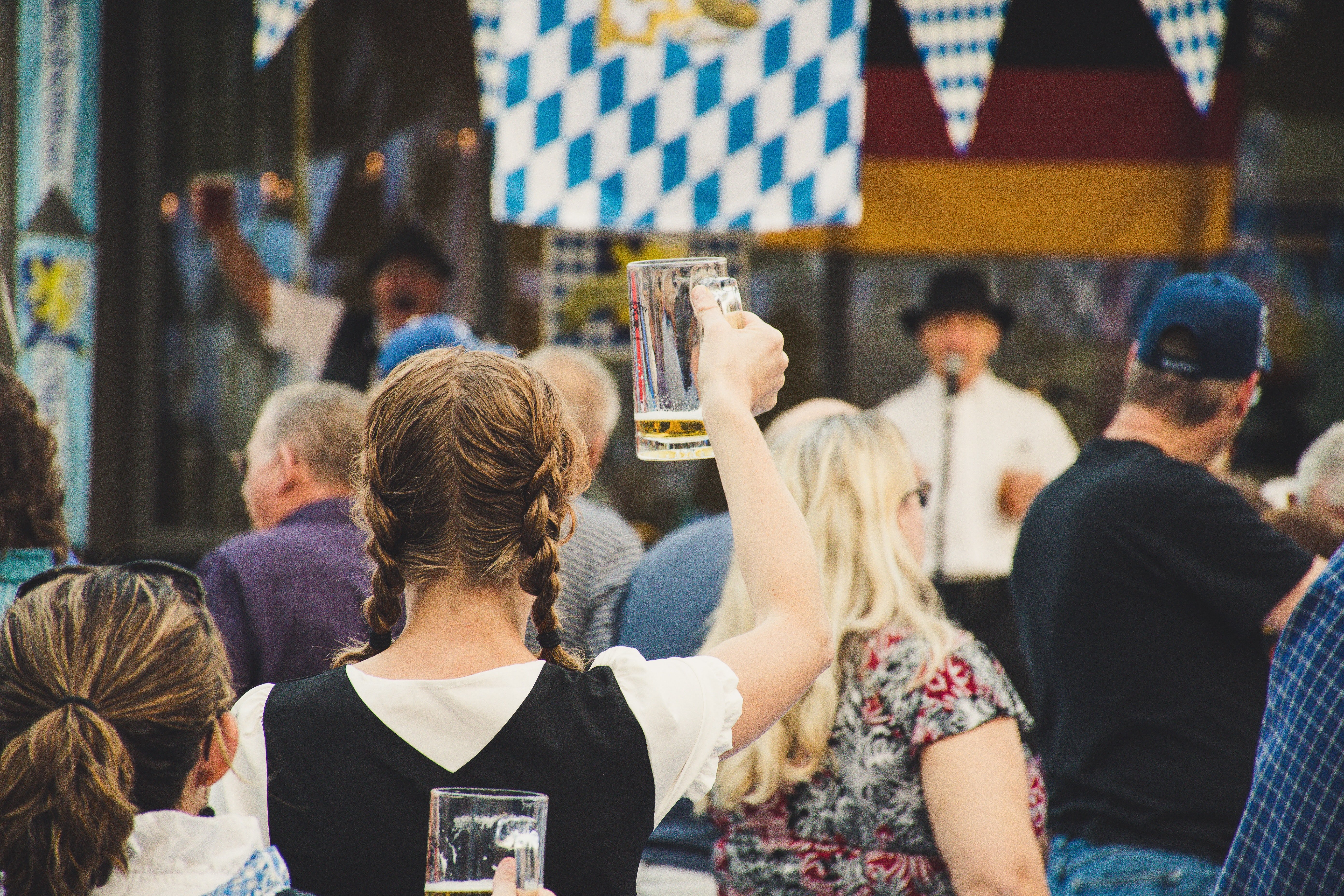 Woman in braids holding a beer stein at Wurstfest 